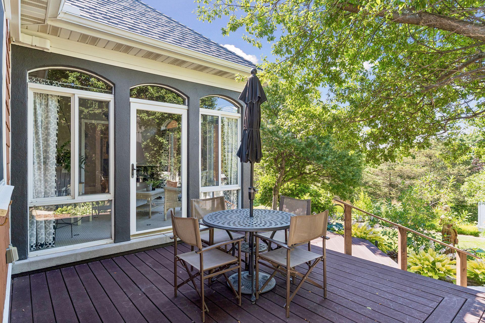 Step directly from the Sunroom onto the deck, perfectly positioned to enjoy the beautifully landscaped backyard.