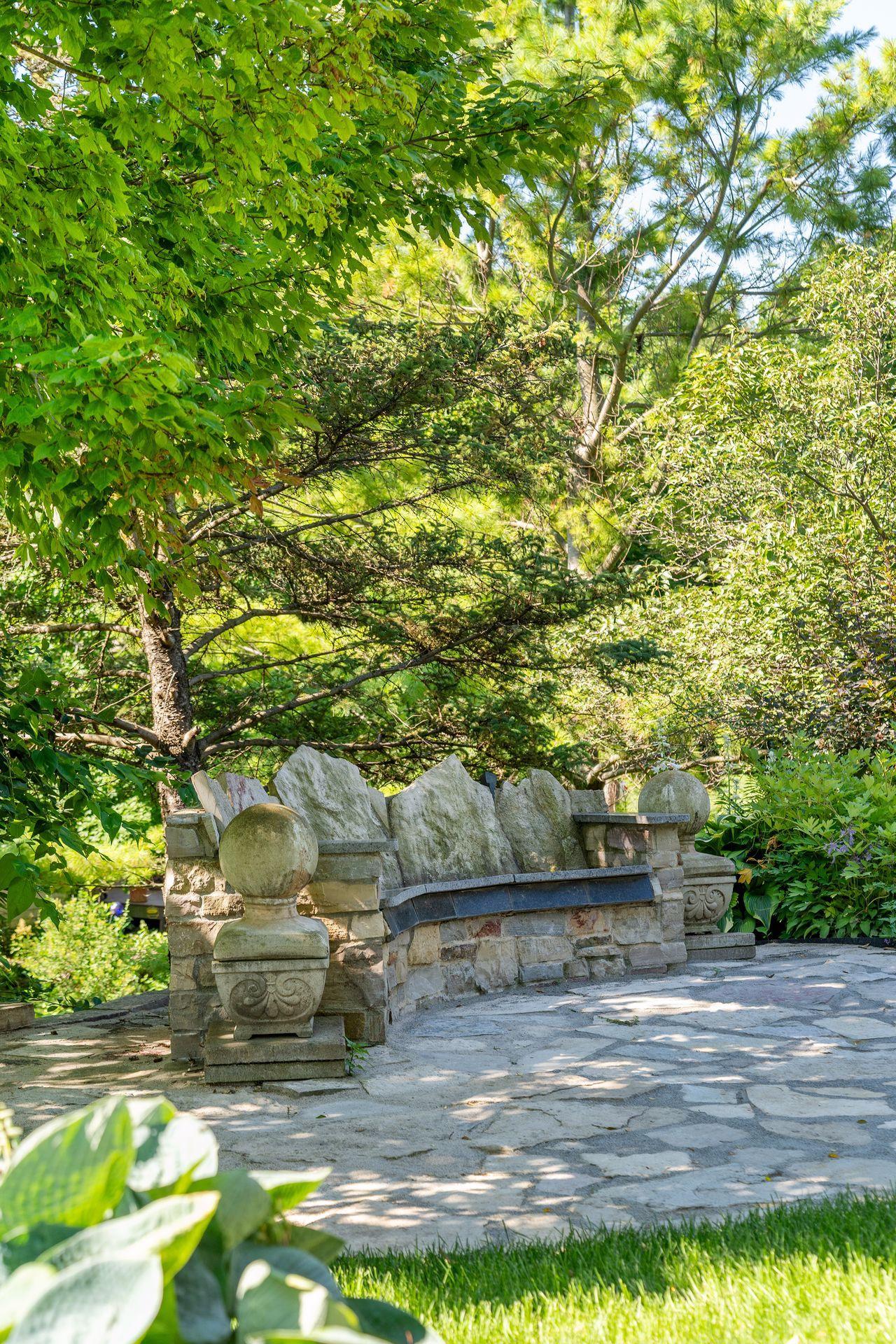 Another view of the custom granite seating area which is an inviting outdoor gathering space.