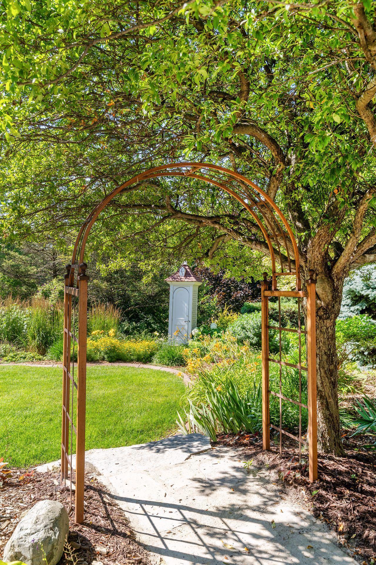 Decorative trellises and colorful gardens add to the charm throughout the backyard.
