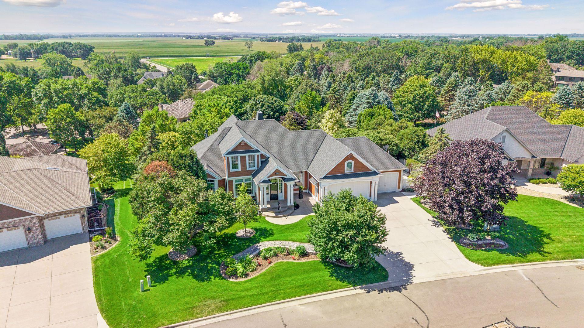 Nestled among mature trees in one of the area's most sought-after neighborhoods, this exceptional custom home offers a setting that's as impressive as the home itself.