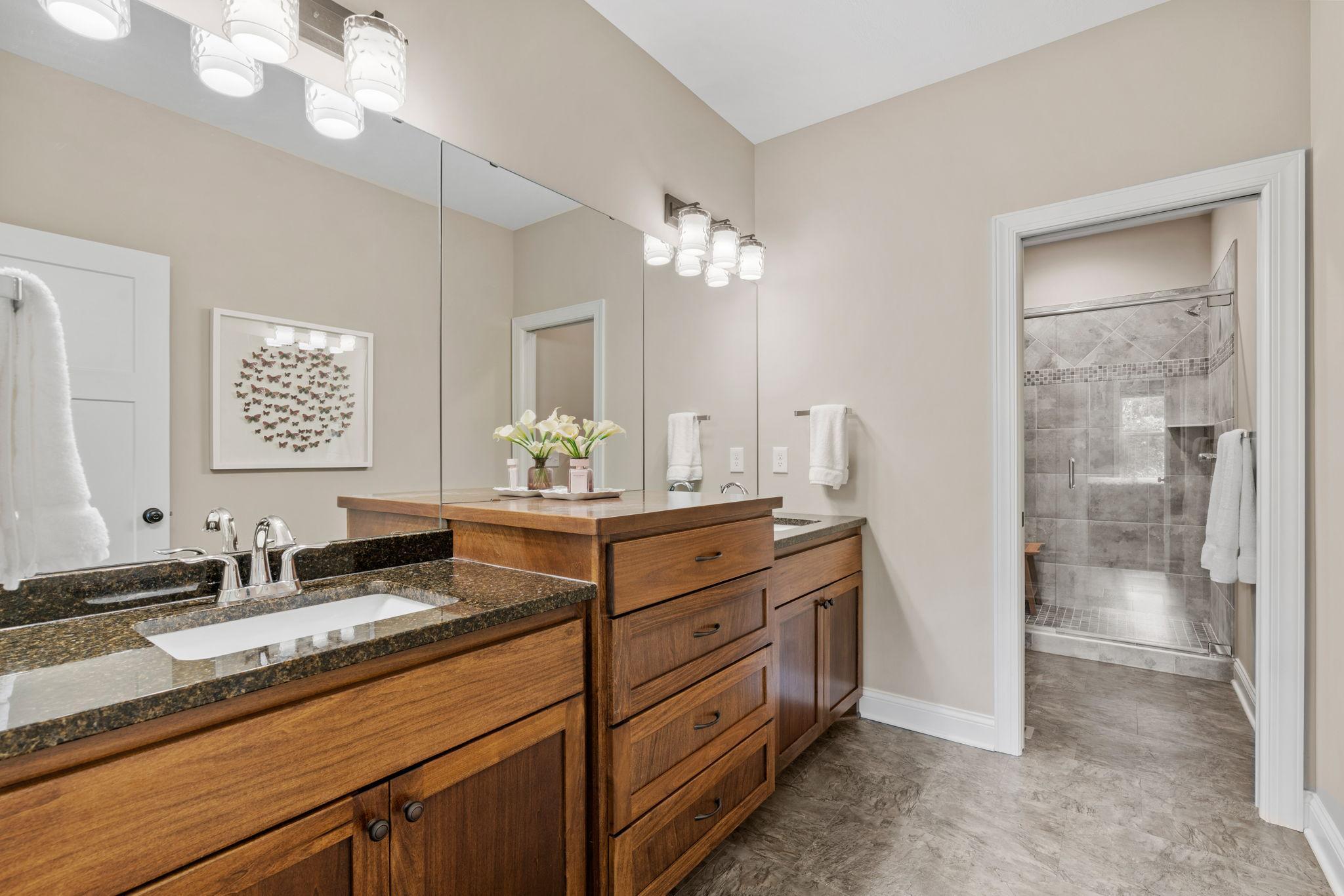 Spacious Primary Suite on ML w/ dual vanities, oversized tiled shower, walk-in closet & walk-through to Laundry