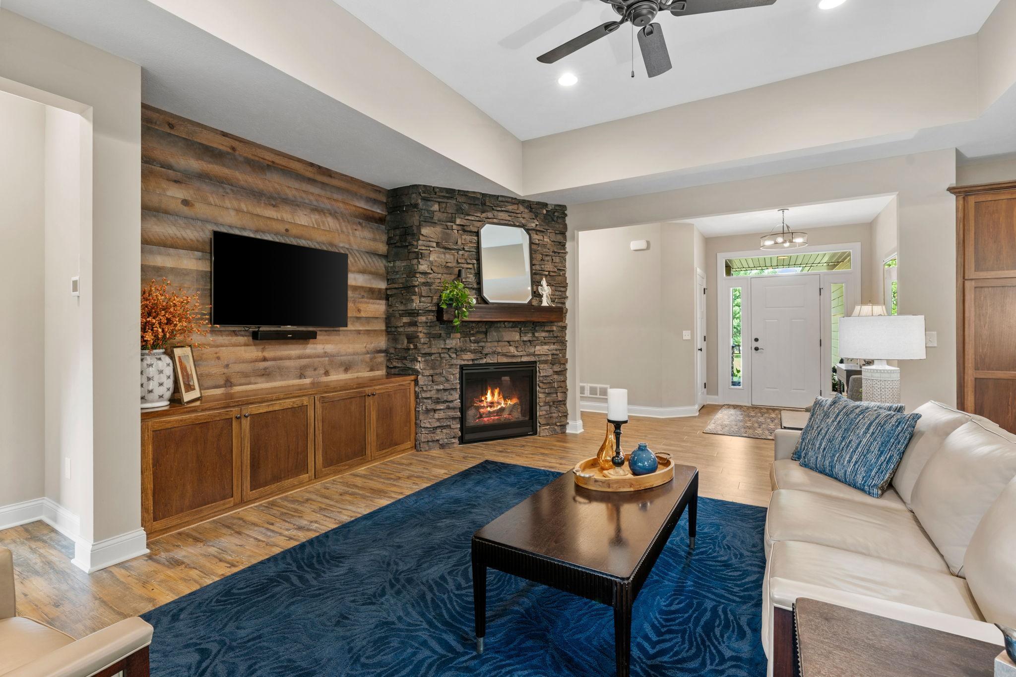 Great Room w/ floor-to-ceiling stone FP, custom built-ins
