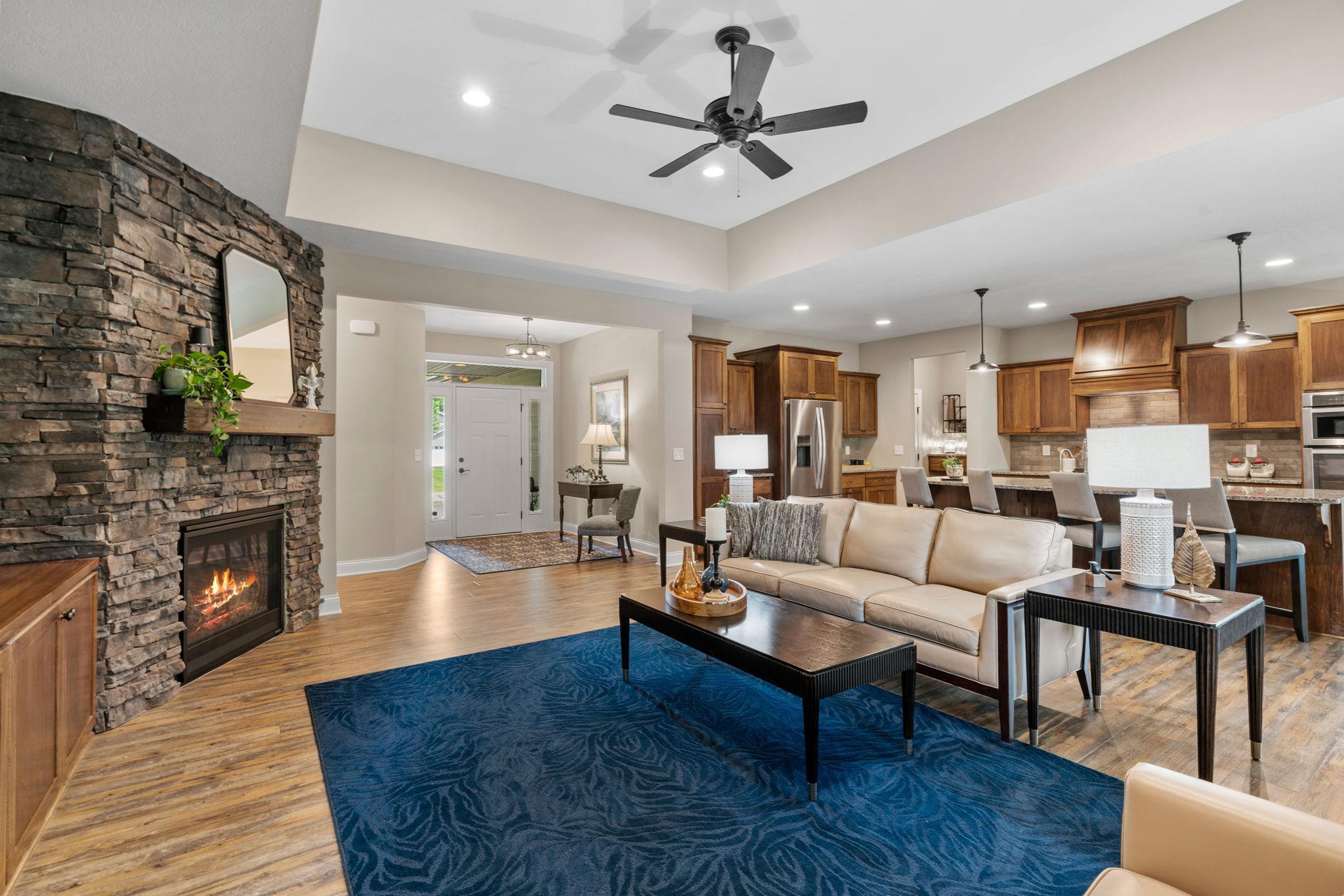 Great Room w/ floor-to-ceiling stone FP, custom built-ins