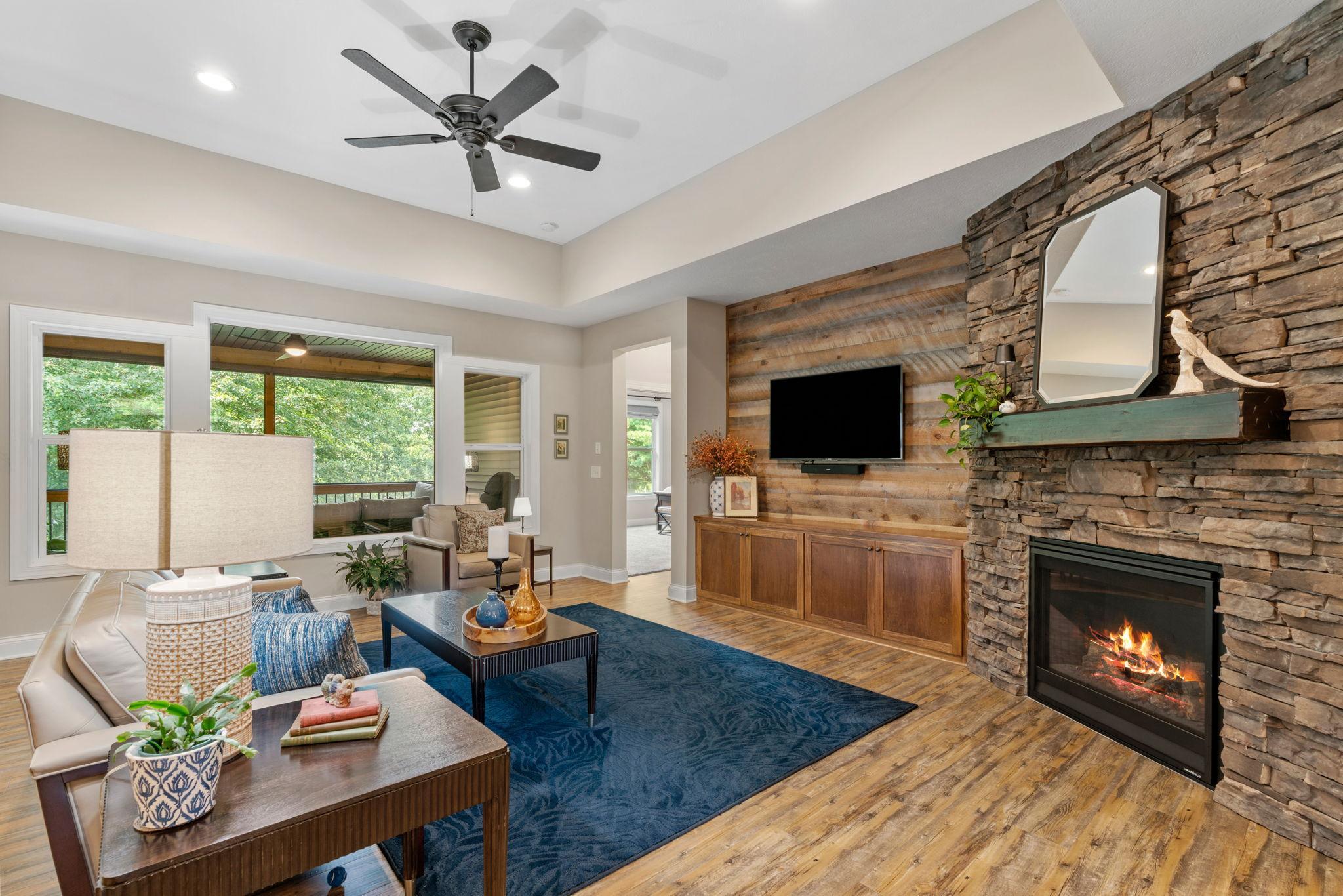 Great Room w/ floor-to-ceiling stone FP, custom built-ins