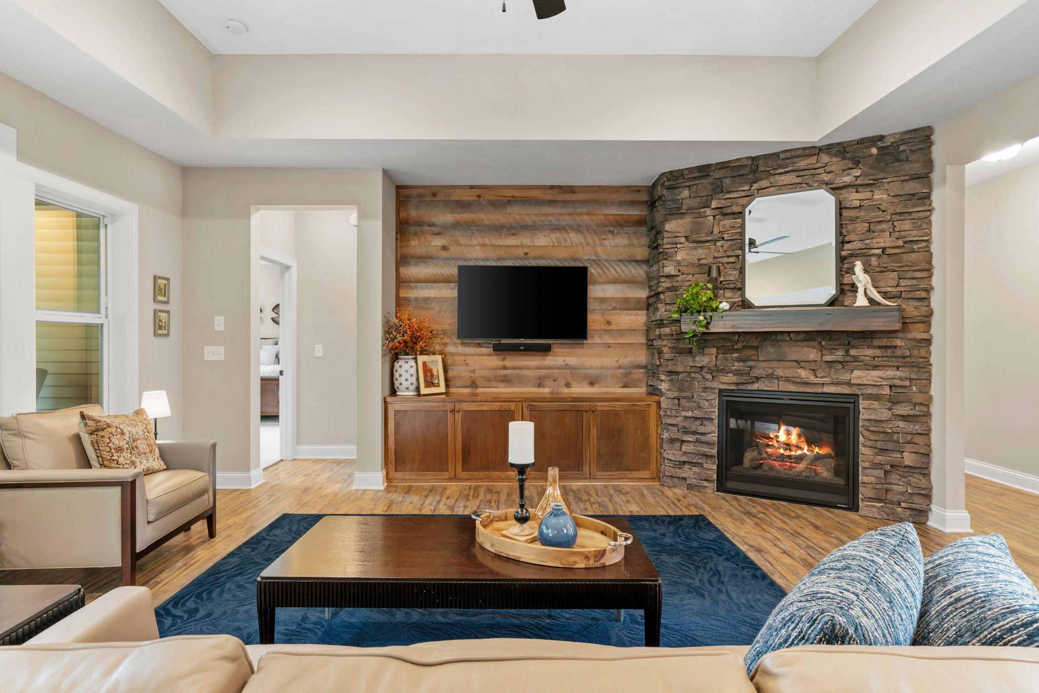 Great Room w/ floor-to-ceiling stone FP, custom built-ins