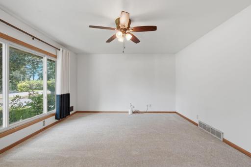 Living Room with large picture window, new carpet and hardwood floors underneath