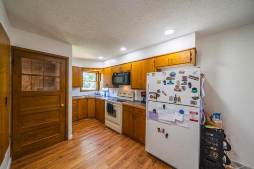 Kitchen with Updated Flooring, Tile Countertops & Recessed Lighting