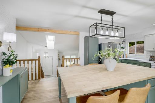 Nice mix of stone, neutrals, and wood materials really makes this kitchen feel cozy and modern