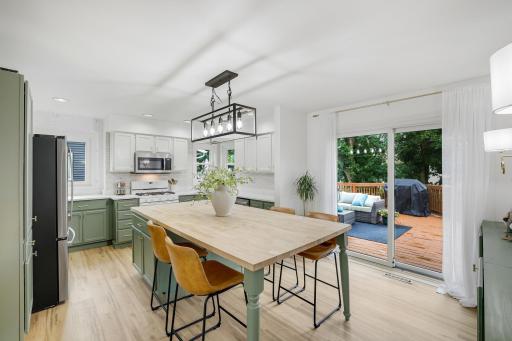 Amazing extra large butcher block island serves as counter space, storage, and dining table