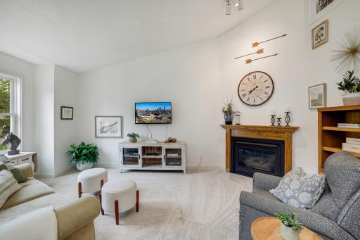 Main living room with vaulted ceiling and cozy gas fireplace