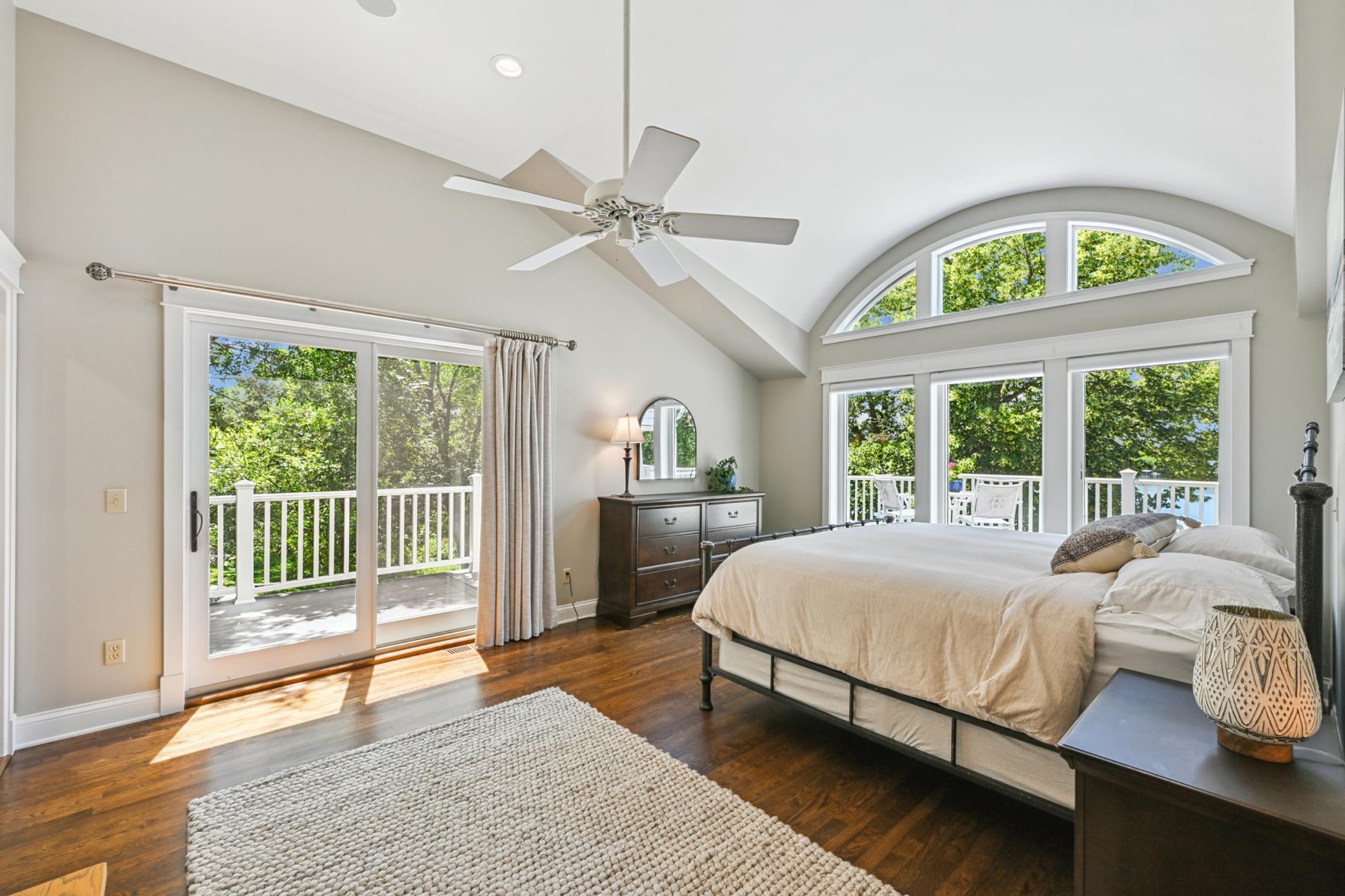 One of four upper-level bedrooms, this sun-filled suite offers a walk-in closet, private bath, and its own balcony that wraps around to the lakeside deck. Are you ready for your morning coffee with a view?