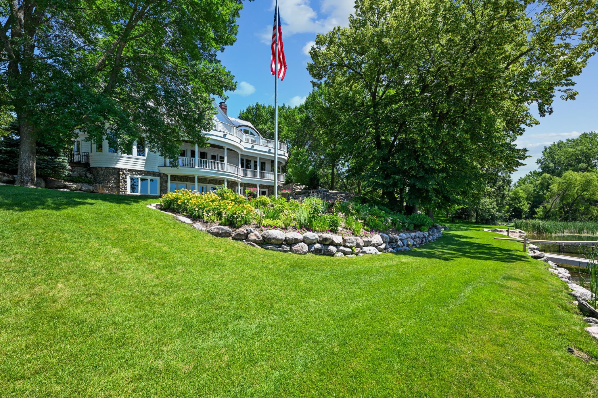 A grand American flag waves proudly over this exceptional lakeshore estate, where timeless architecture meets manicured grounds and a gently sloping lawn to the water’s edge. Celebrate lake living on the grand shores of West Lake Sylvia in Annandale.