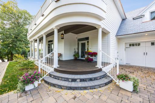 A charming wraparound porch welcomes guests from both the drive and lakeside. Just under an hour from the Twin Cities, this inviting entrance sets the tone for relaxed luxury at the lake.