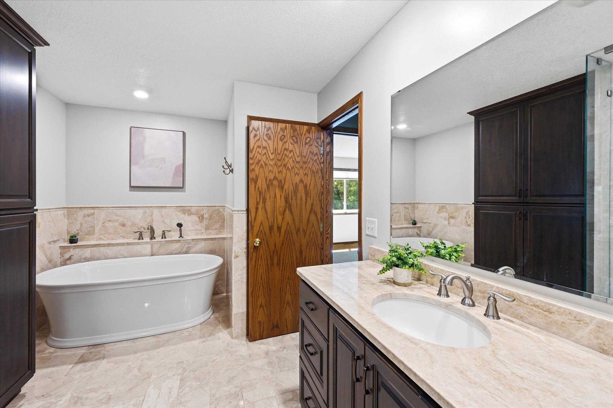 Enjoy both a soaking tub and tiled walk-in shower.