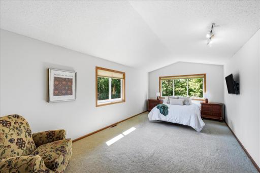 Upper level primary bedroom. Vaulted ceilings create an airy feel.