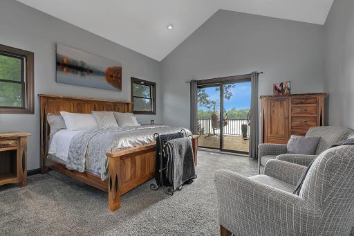 Primary owners suite with access to the deck and immediate lake views.