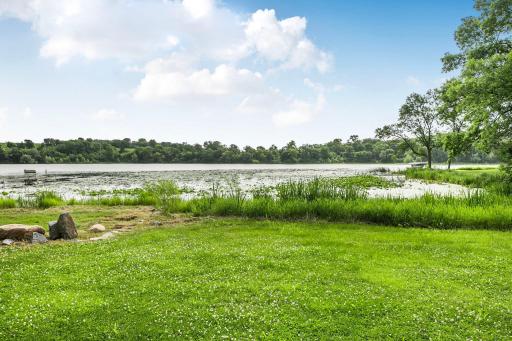 Flat green space abuts lake side. there is a beach there. Seller has not yet cleared this year.