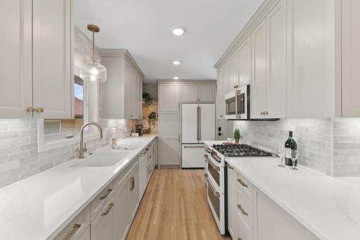 Farmhouse sink, tile backsplash, and CAFE series appliances. WOW!