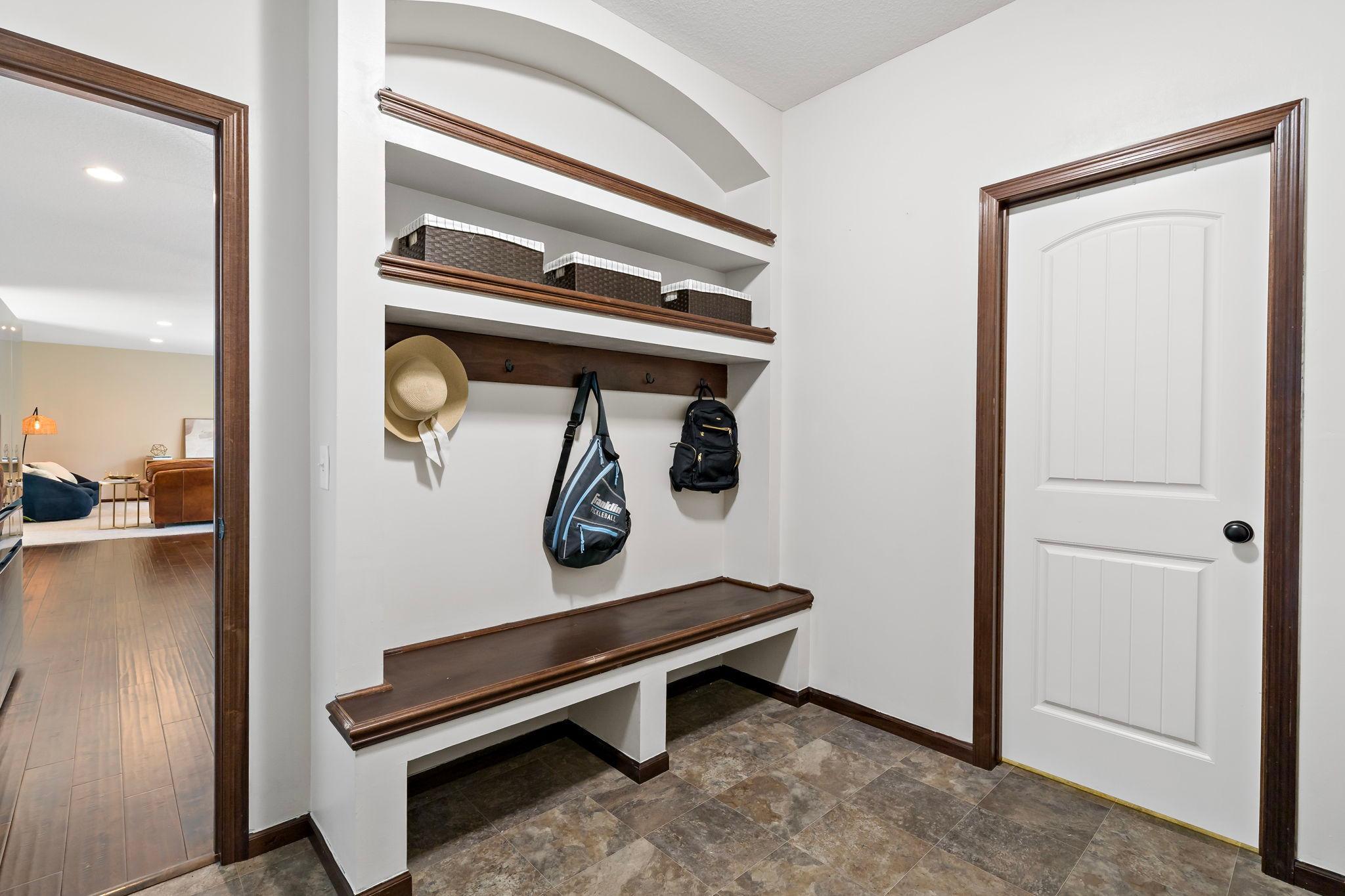 Mudroom bench area with large walk in closet