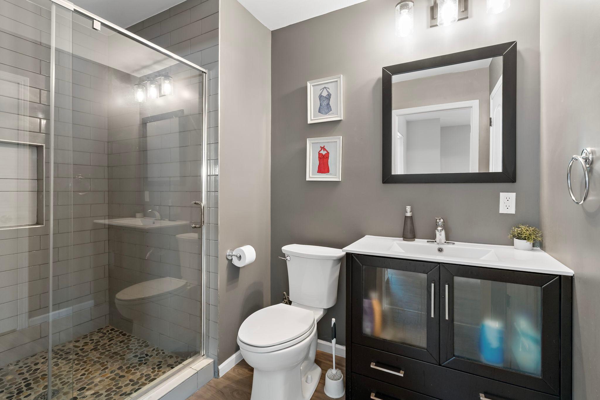 Lower level 3/4 bath with tiled shower and large linen closet
