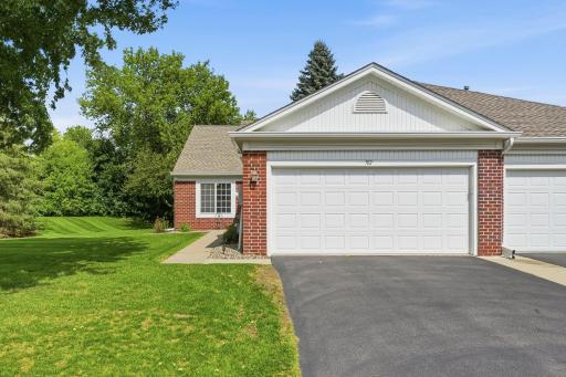 Well-maintained brick & vinyl exterior with asphalt driveway