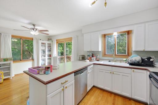 Hardwood floors in kitchen & dining bring warmth to the cheerful spaces