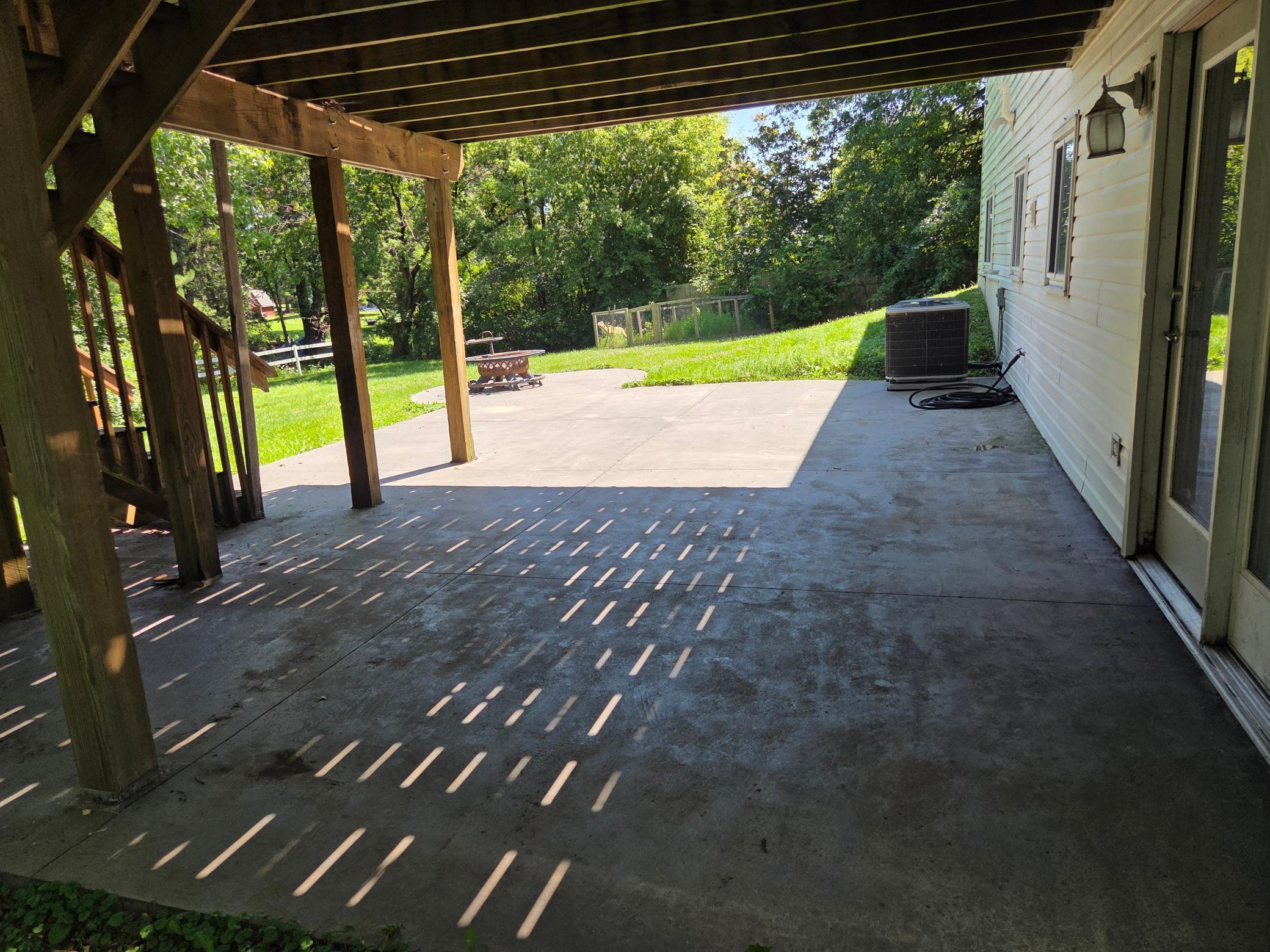 Concrete patio installed three years ago - hang the string lights & bring the outdoor furniture!
