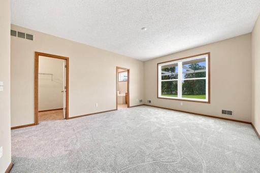 The primary bedroom is spacious and features a large walk-in closet and private bath.