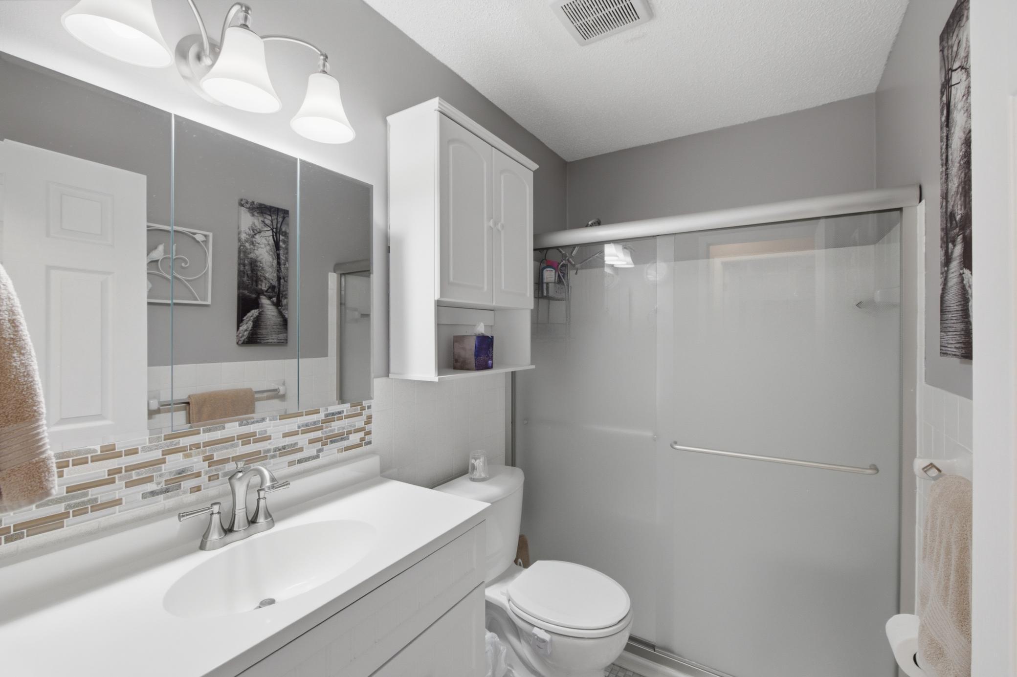 The bathroom sits across from both bedrooms.