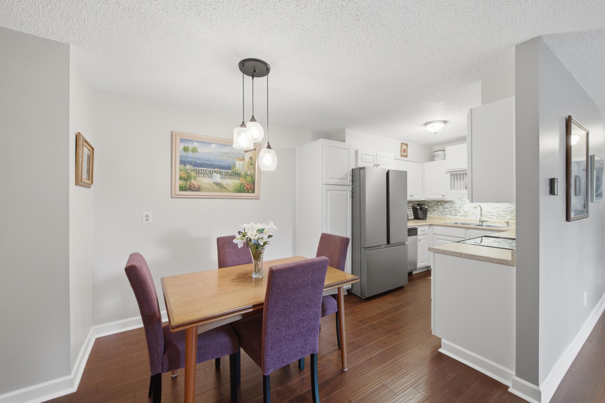 Attractive lighting accents the cozy setup. The hall to the right leads to the bedrooms and bathroom