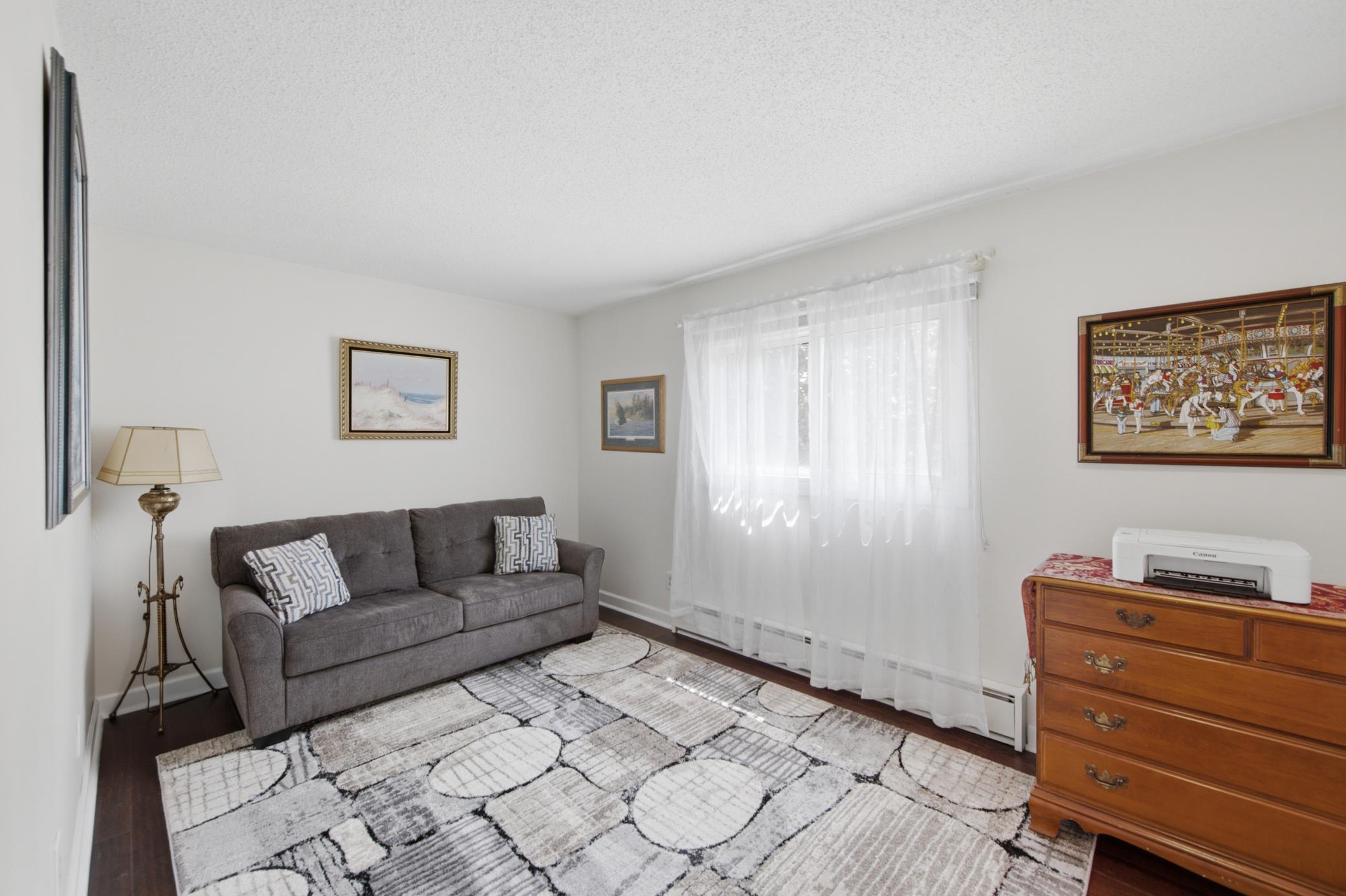 The primary bedroom is currently staged as a sitting room.