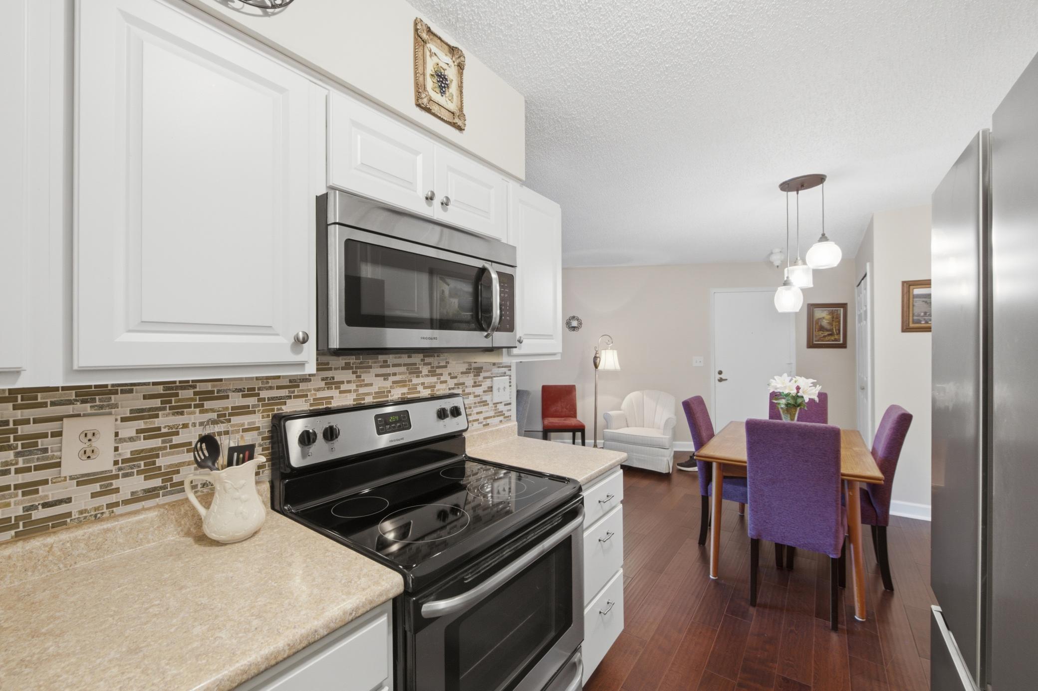 The dining room sits directly off the kitchen. The wood-like flooring adds warmth to the space and updated lighting brightens your dining experience.