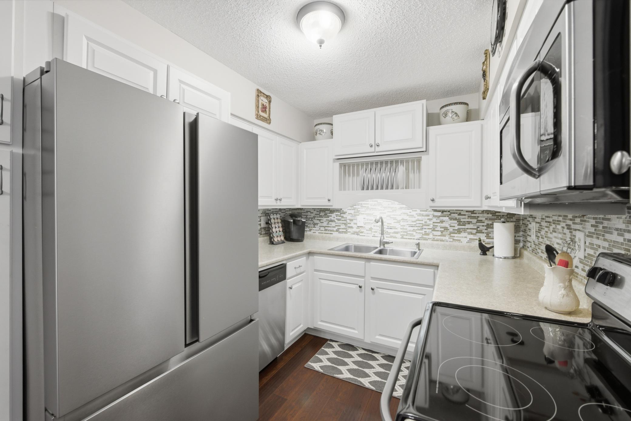 The kitchen features enameled cabinetry and stainless steel appliances. Store your refrigerated items in the french door fridge with a pull out freezer.