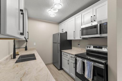 New appliances, hardware, wood cabinet w/ soft close drawers.