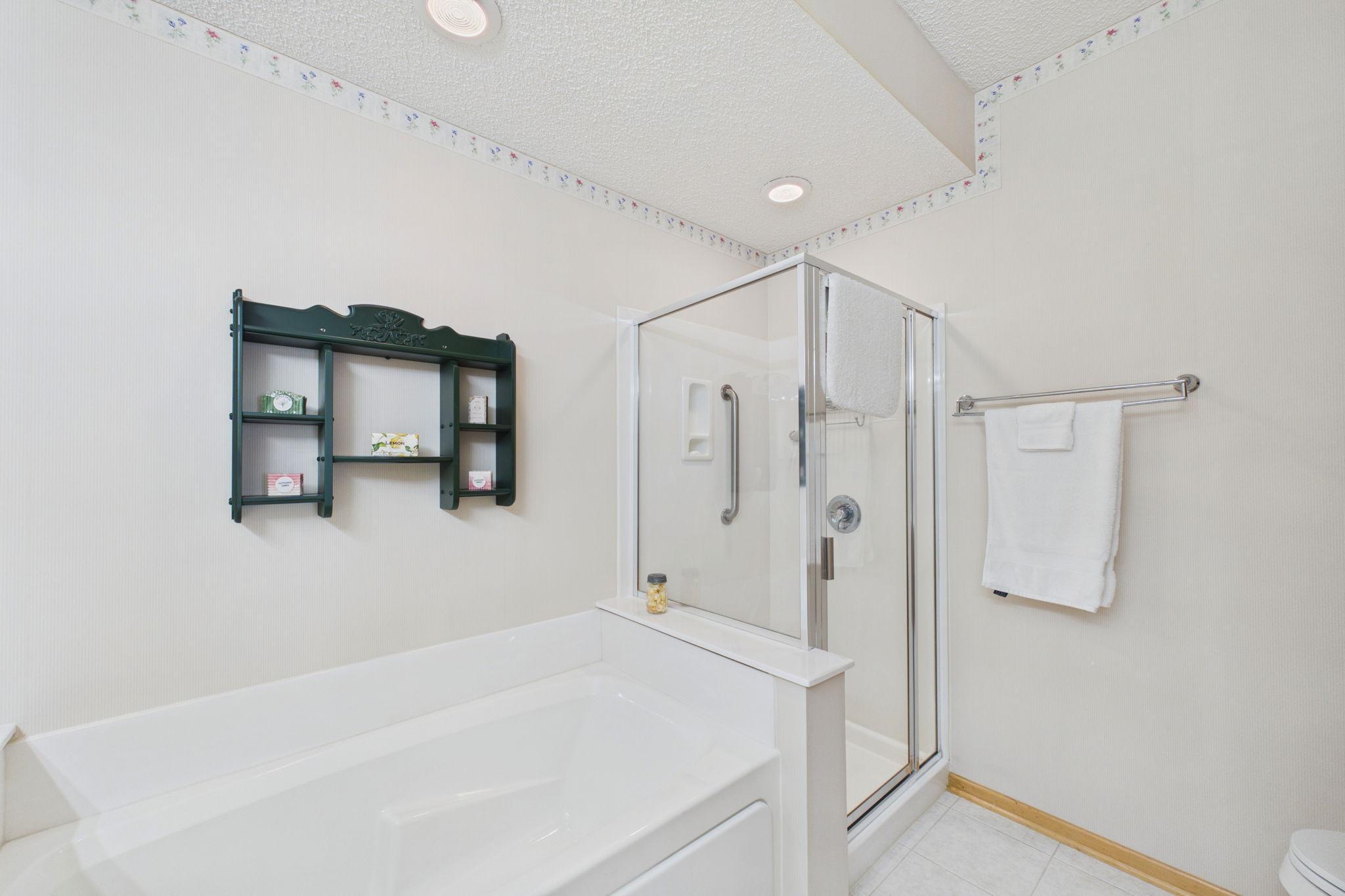 Primary bathroom with soaking tub and stand up shower