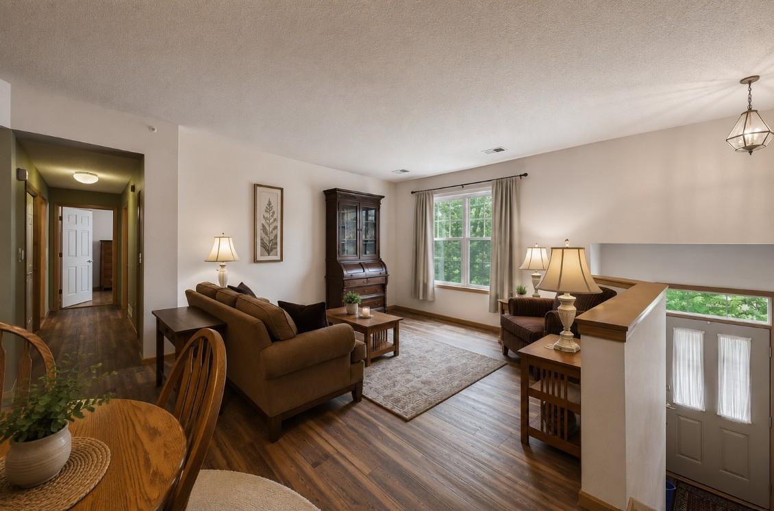 Living room with new flooring throughout. Virtually staged