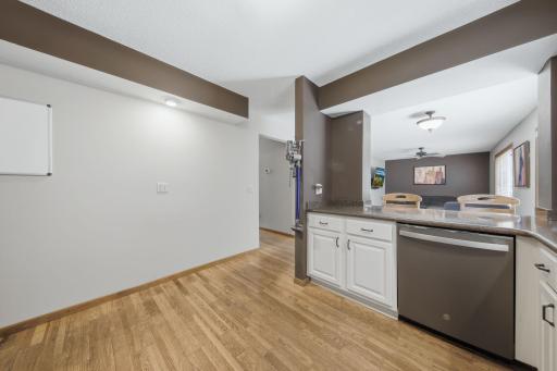 Kitchen peninsula has room for a couple of stools, and looks into the informal dining space and main level family room.