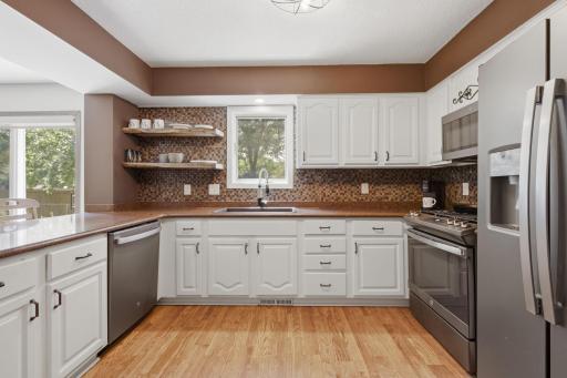 Stainless-steel appliances, tile backsplash, white cabinets and plenty of workspace in your new kitchen.