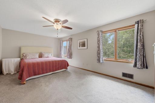 Upper level primary suite is the fourth of four bedrooms on one level.