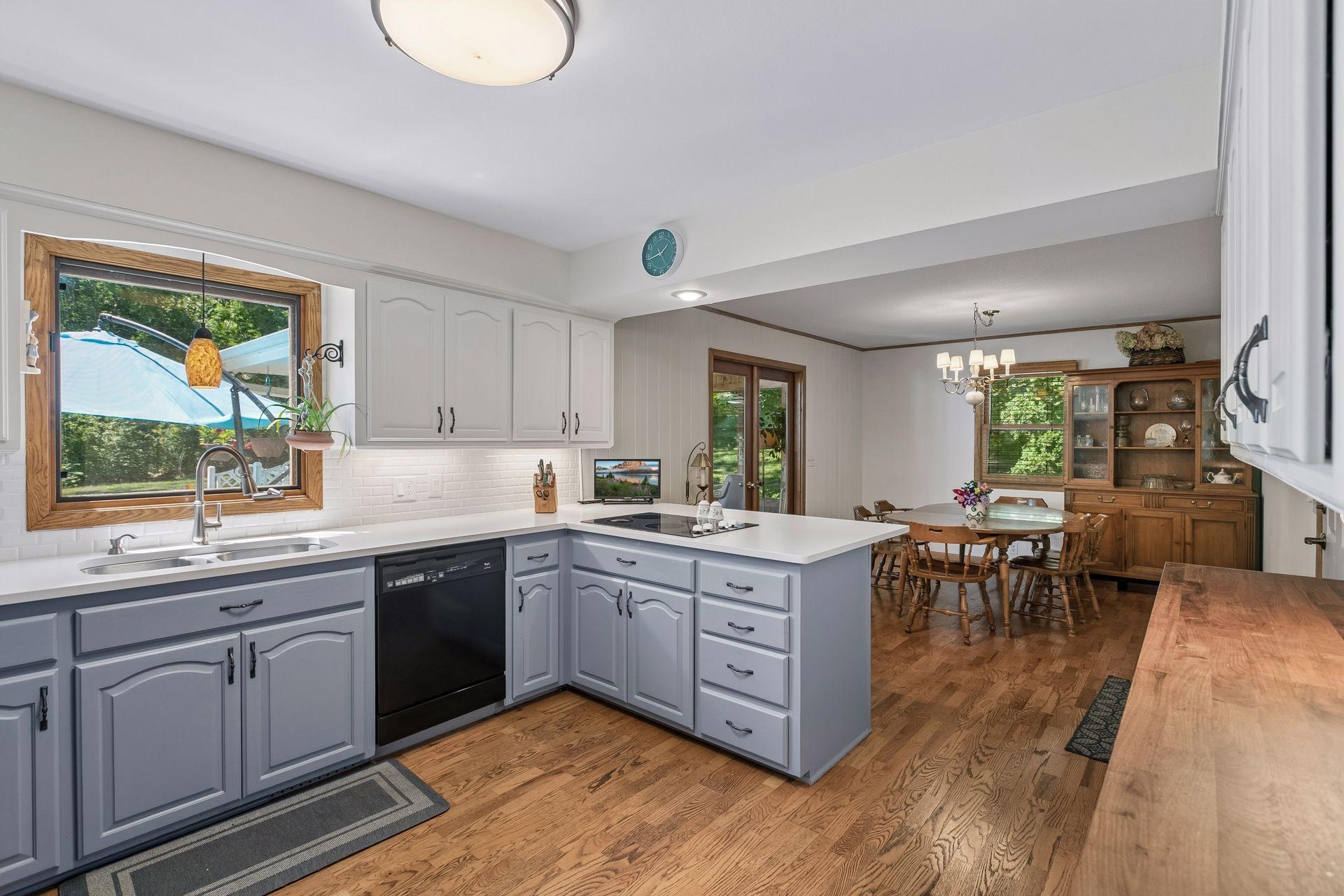 This darling kitchen and informal dining area has updated cabinets and counter tops! So cute!