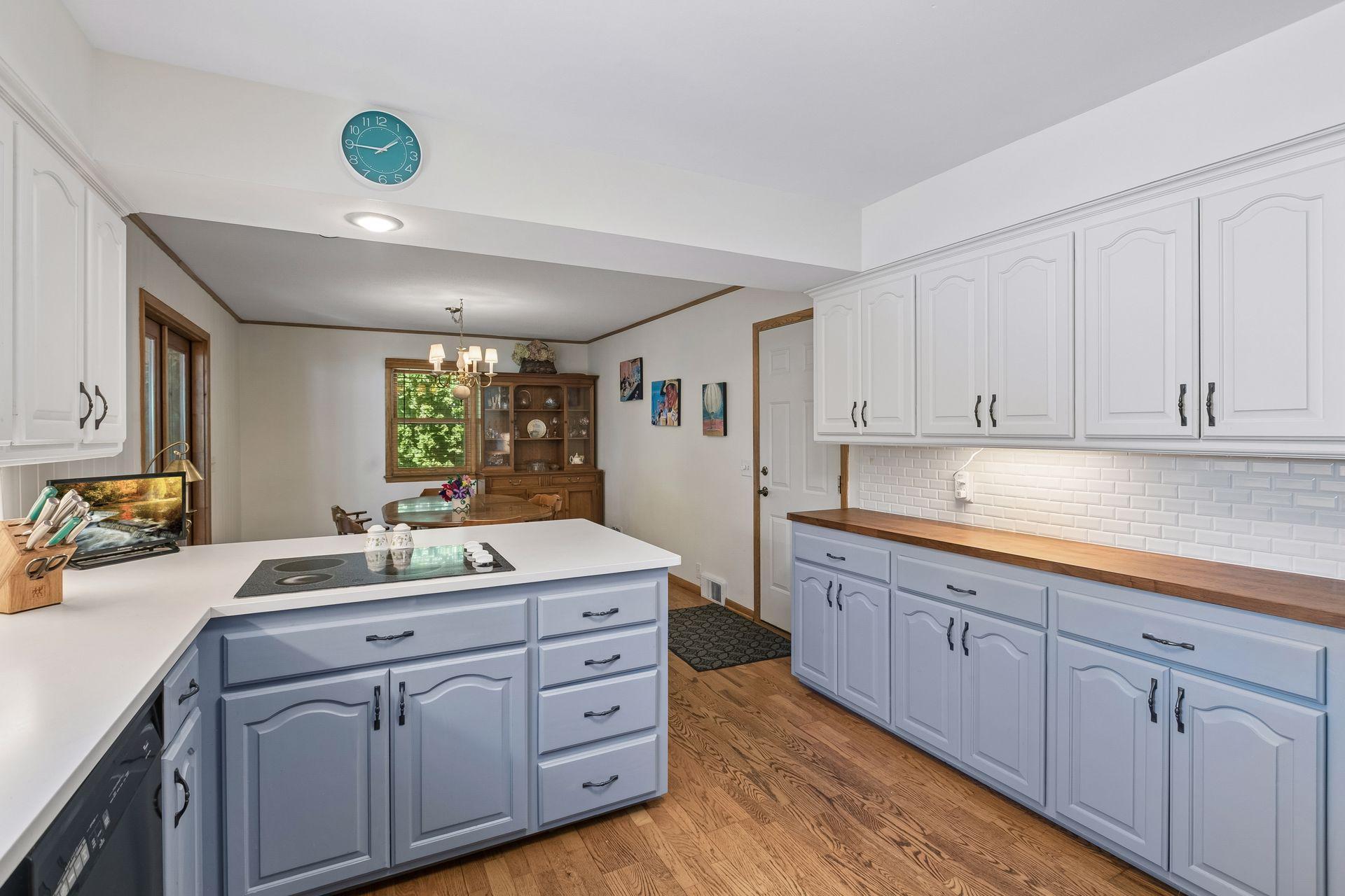 Modern backsplash compliments the cute cabinetry in the kitchen