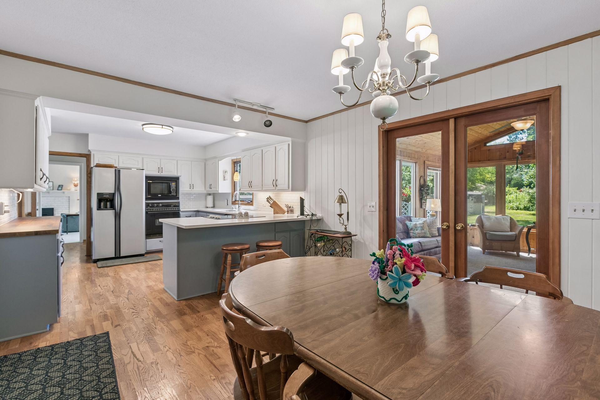 The kitchen and dining room effortlessly connect to the 4-season porch