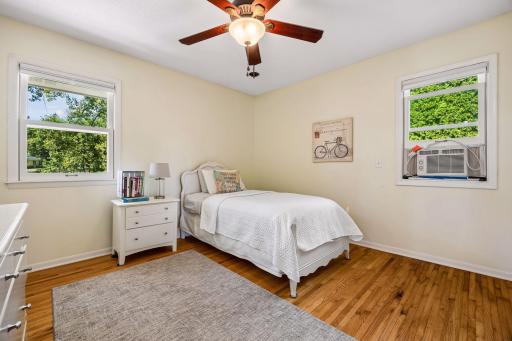 The 2nd bedroom also has wood floors and ceiling fan/lighting