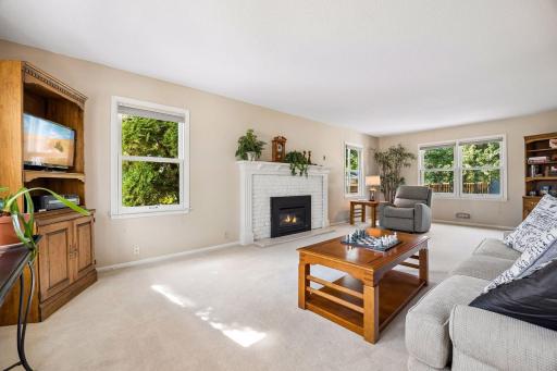 The main living room has lots of windows and a lovely fireplace