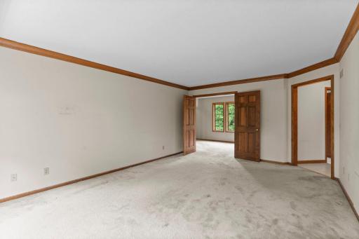 Double doors are crown moulding in the large primary bedroom