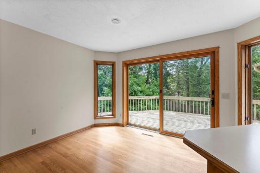 Eat in informal dining space with wood floors and huge patio door leading to the deck for alfresco dining