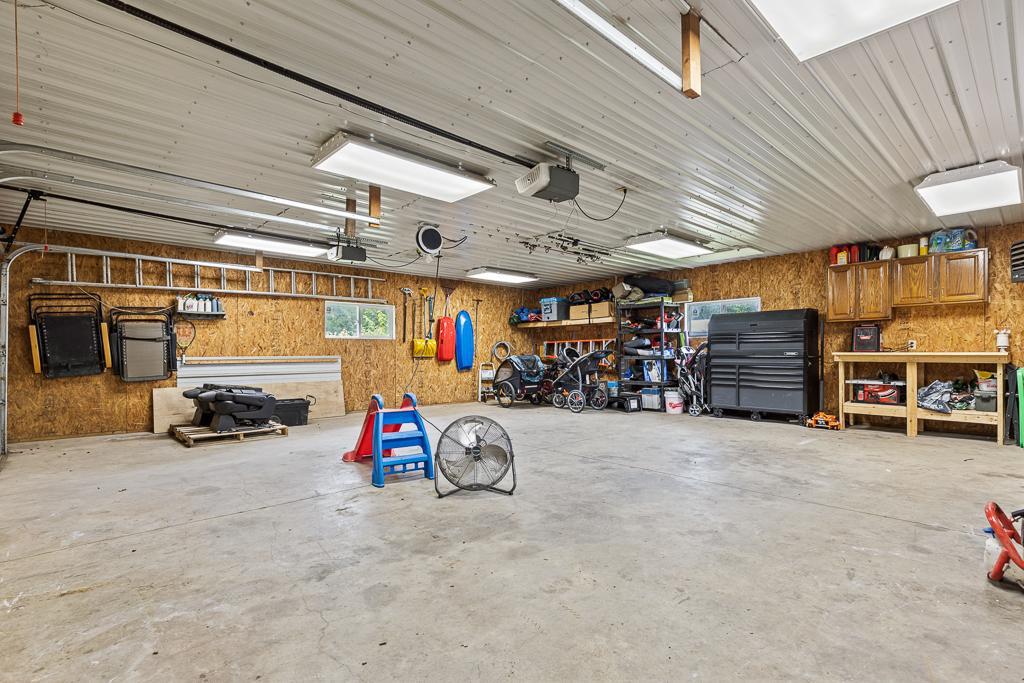Oversized garage offers ample space for storage and workspace