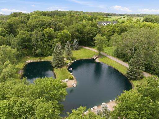 The asphalt driveway leads past this picturesque pond and waterfall.