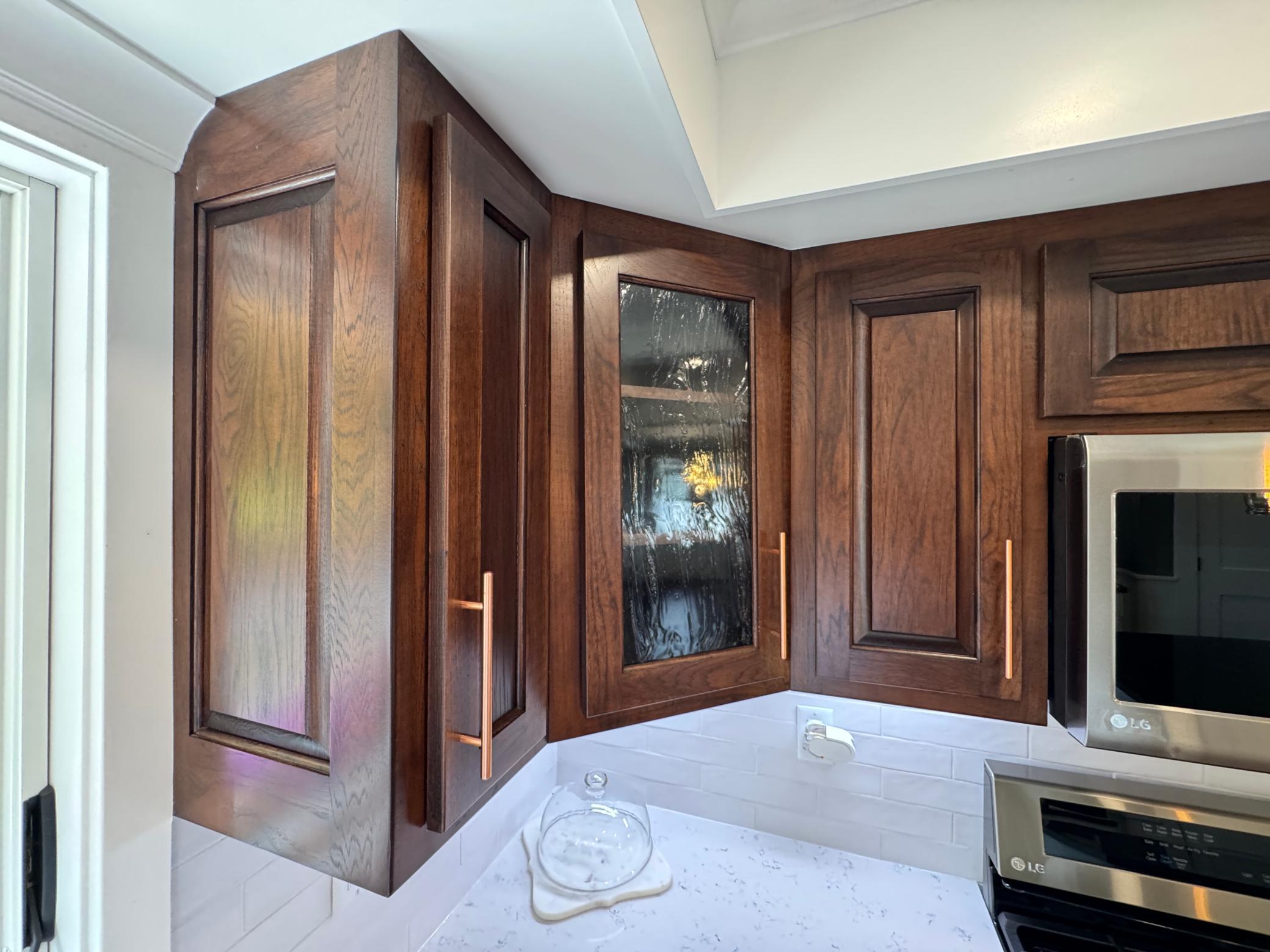 Super high-end cathedral dark Oak cabinetry with reeded glass (aka-Fluted glass).