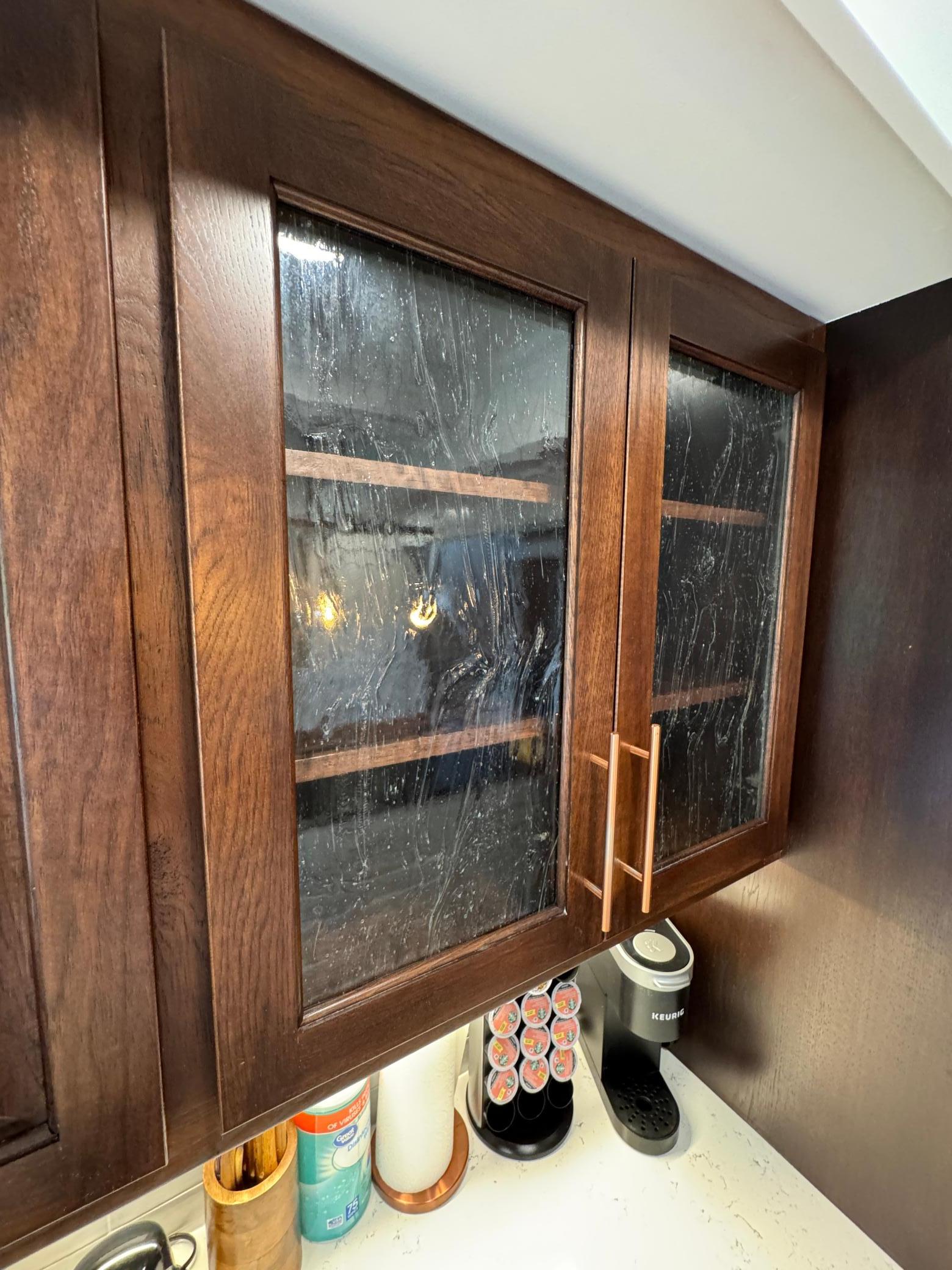 Super high-end cathedral dark Oak cabinetry with reeded glass (aka-Fluted glass).